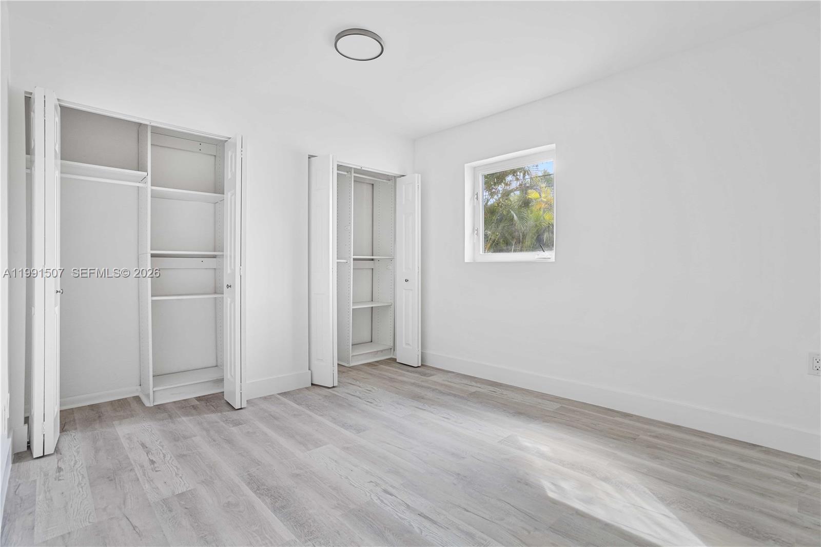 4157 Southwest 49th Court Dania Beach, FL 33314 - Photo 25 of 46 an empty room with wooden floor closet and windows
