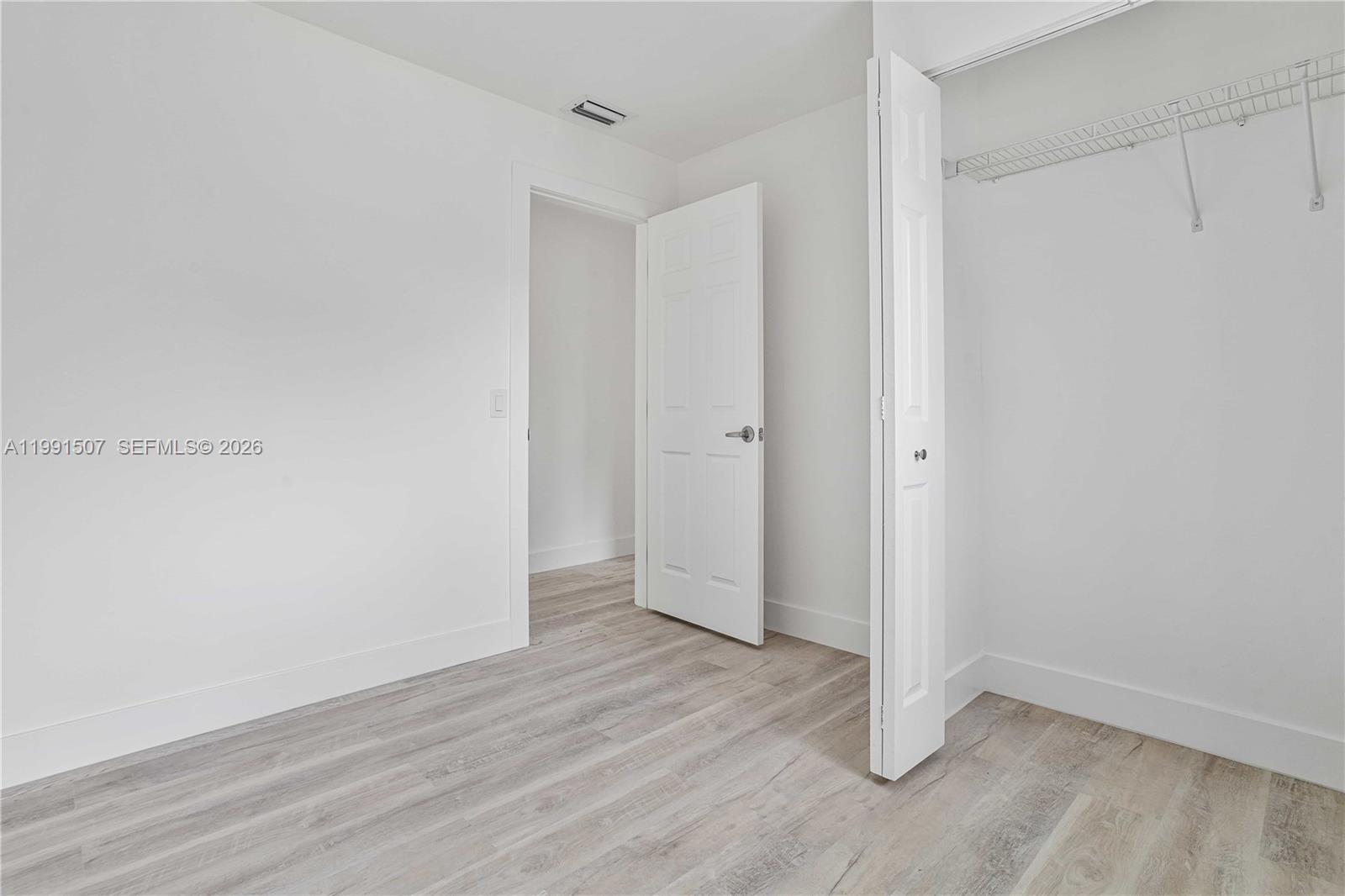 4157 Southwest 49th Court Dania Beach, FL 33314 - Photo 27 of 46 a view of an empty room with wooden floor
