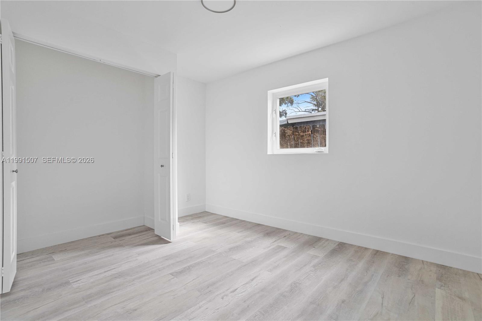 4157 Southwest 49th Court Dania Beach, FL 33314 - Photo 30 of 46 an empty room with wooden floor and window