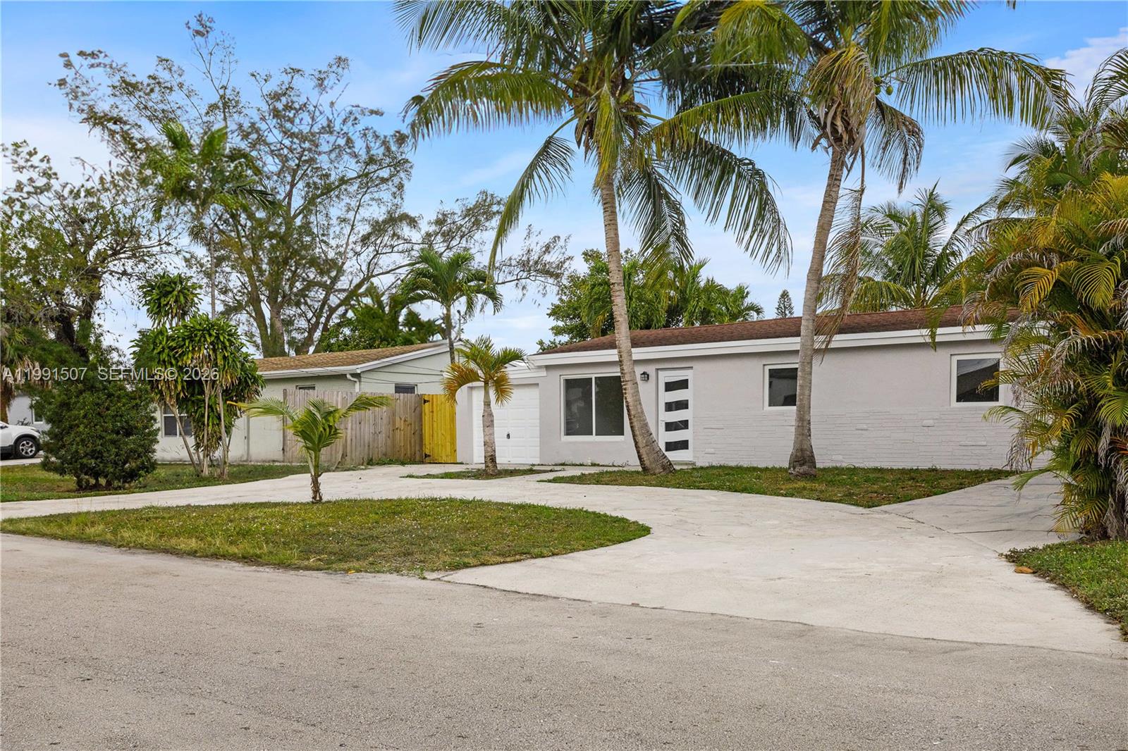 4157 Southwest 49th Court Dania Beach, FL 33314 - Photo 42 of 46 a view of a house with a yard and palm trees