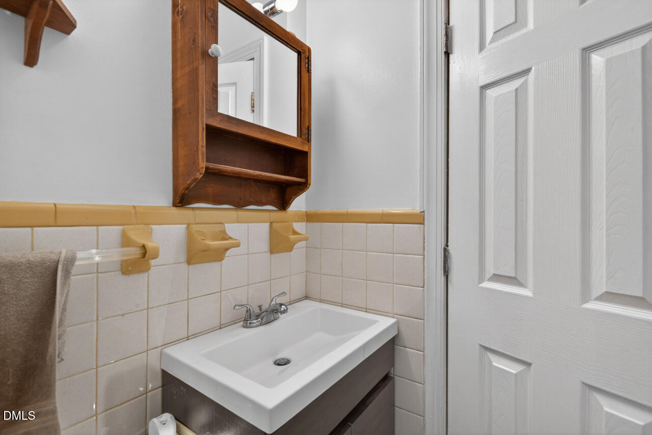 1420 Goodwin Road Durham, NC 27712 - Photo 32 of 54 a bathroom with a sink a toilet and mirror
