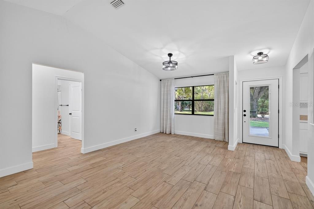 171 William Street Edgewater, FL 32141 - Photo 5 of 40 wooden floor in an empty room with a window