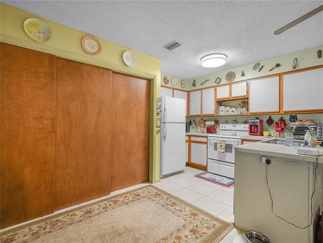 a kitchen with granite countertop a sink cabinets stainless steel appliances and a window
