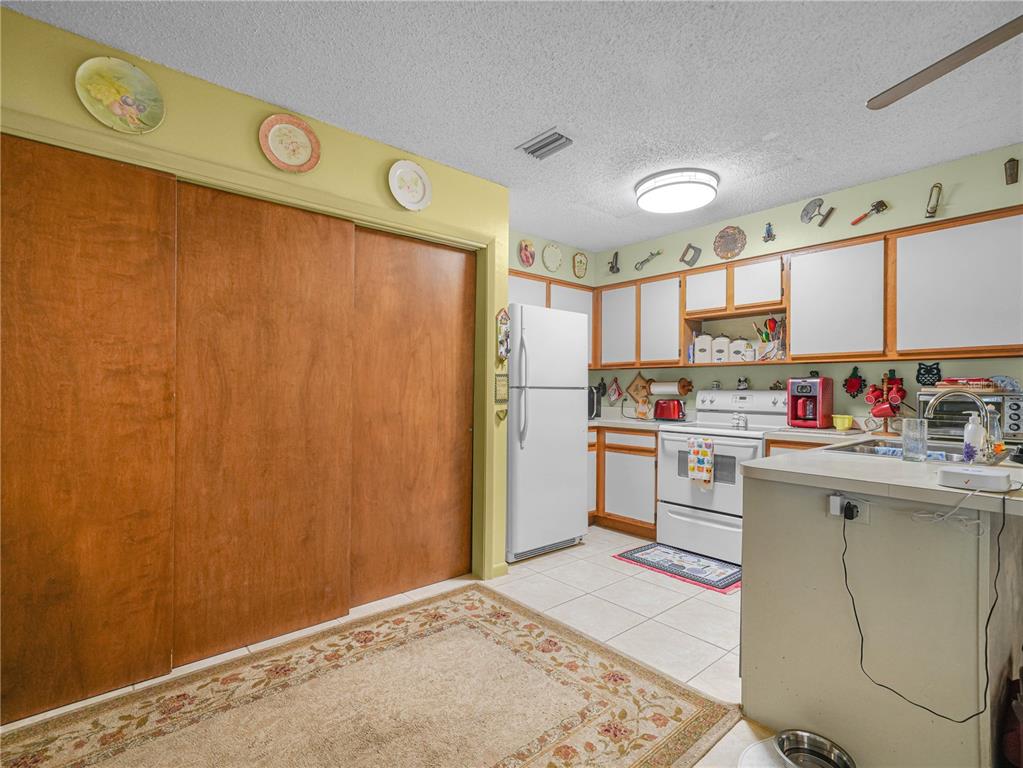 1100 Golden Bough Road Lake Wales, FL 33898 - Photo 19 of 49 a kitchen with granite countertop a sink cabinets stainless steel appliances and a window