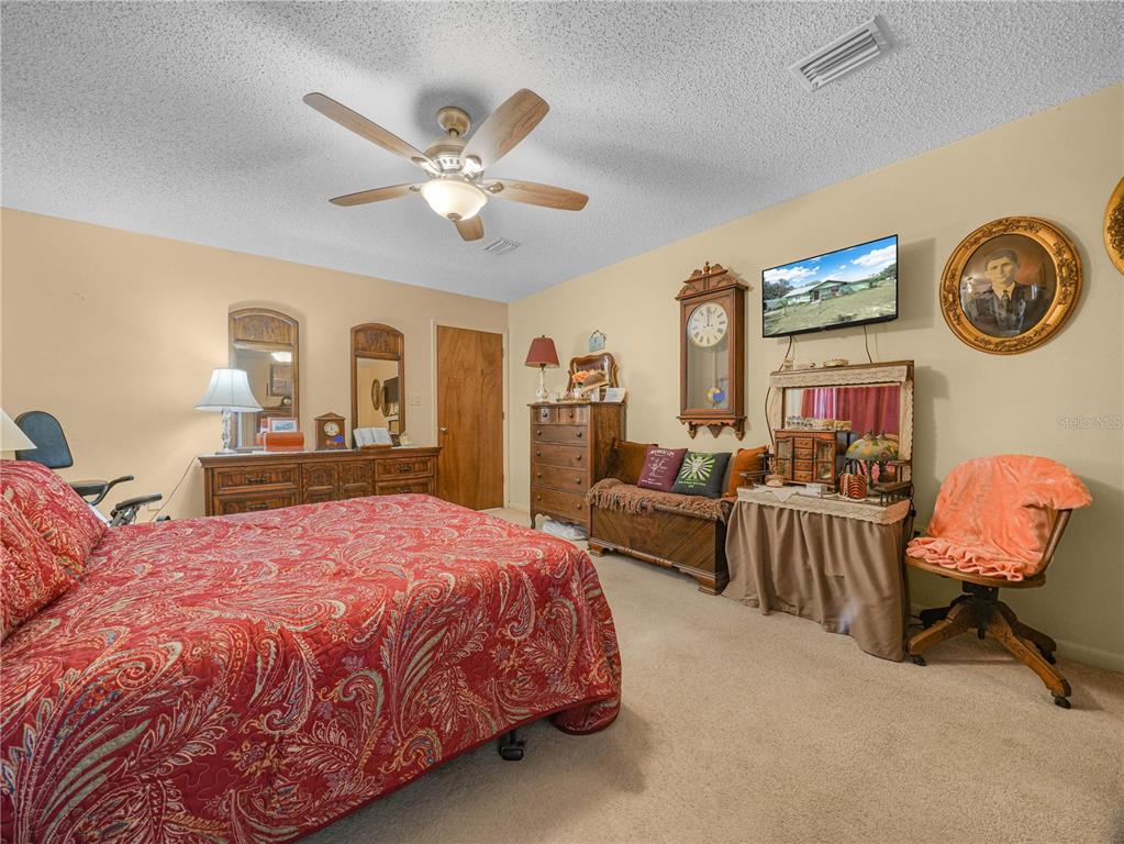 1100 Golden Bough Road Lake Wales, FL 33898 - Photo 26 of 49 a bedroom with a bed a chandelier and dresser
