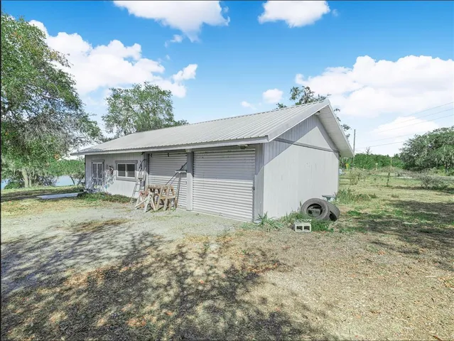 a view of house with backyard