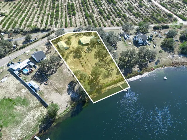 an aerial view of a residential houses with outdoor space