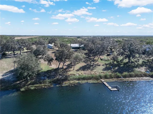 an aerial view of a houses with ocean view
