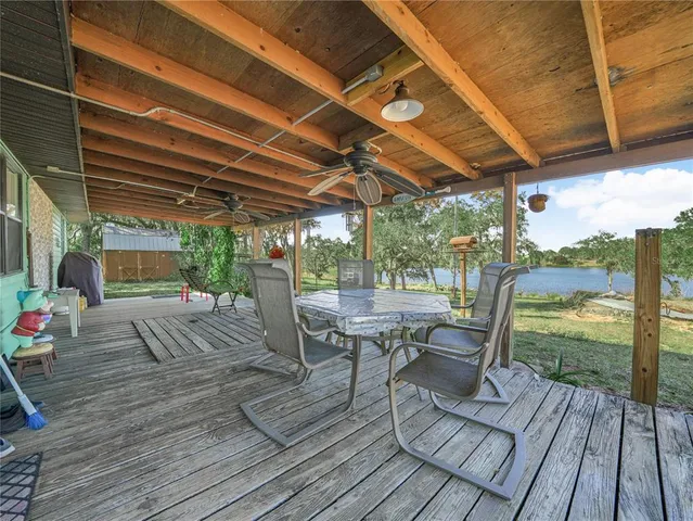 a view of a patio with table and chairs and wooden floor