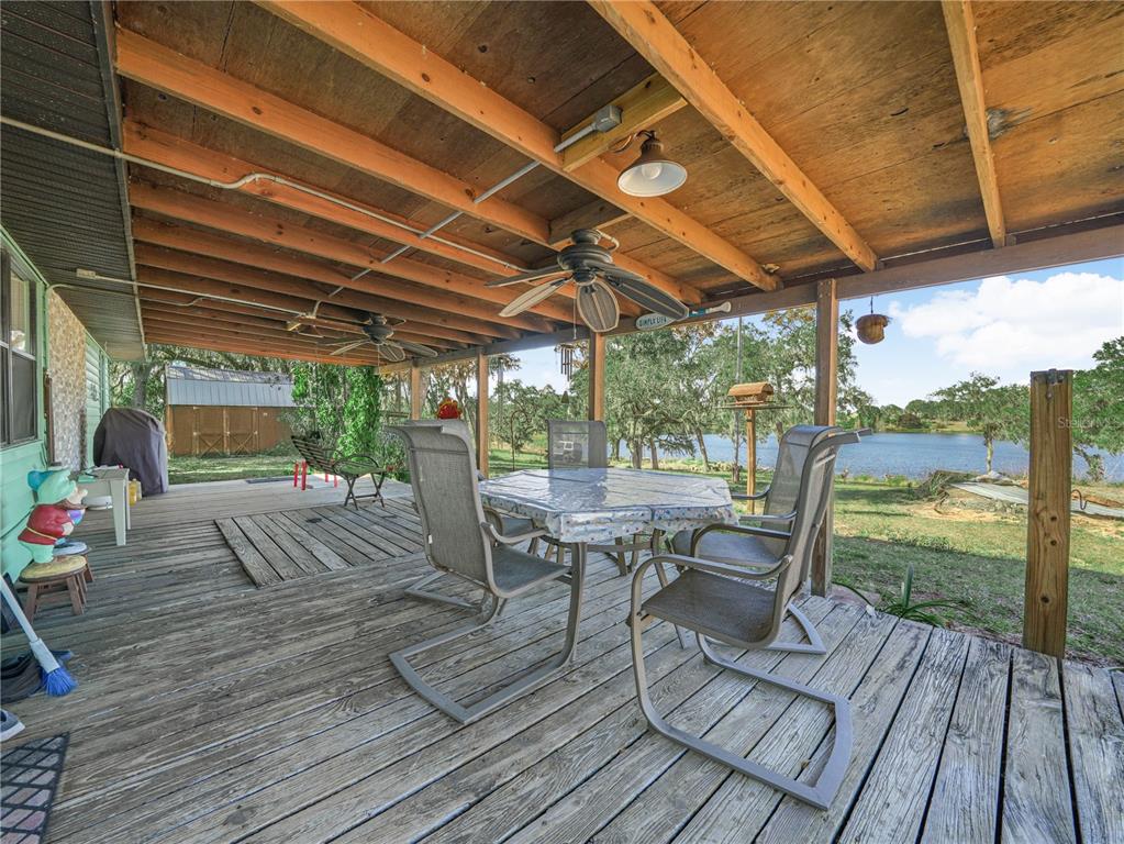 1100 Golden Bough Road Lake Wales, FL 33898 - Photo 9 of 49 a view of a patio with table and chairs and wooden floor
