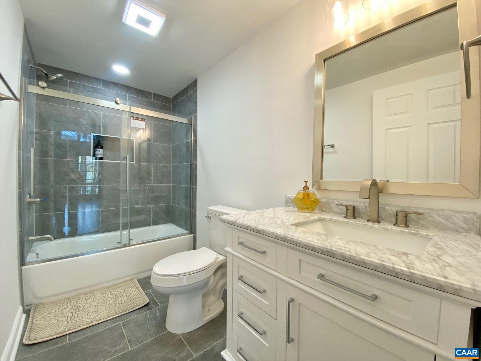24 Tanglewood Road Palmyra, VA 22963 - Photo 11 of 23 a bathroom with a granite countertop sink a toilet and shower