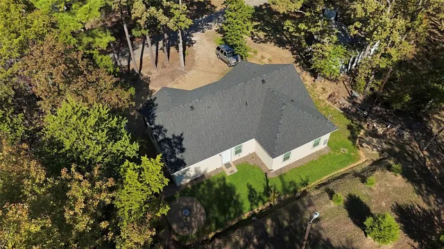 an aerial view of a house with a yard