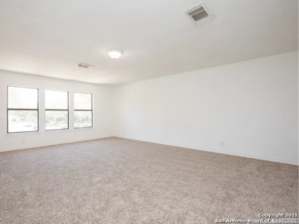 an empty room with a empty space and windows