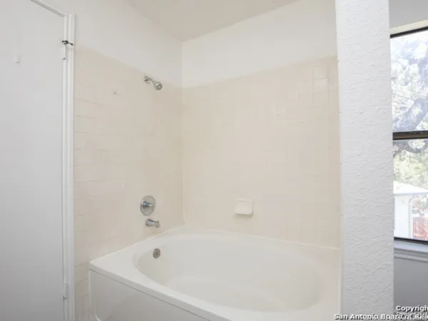 a white bath tub sitting next to a window