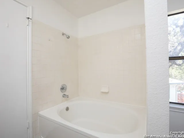 a white bath tub sitting next to a window