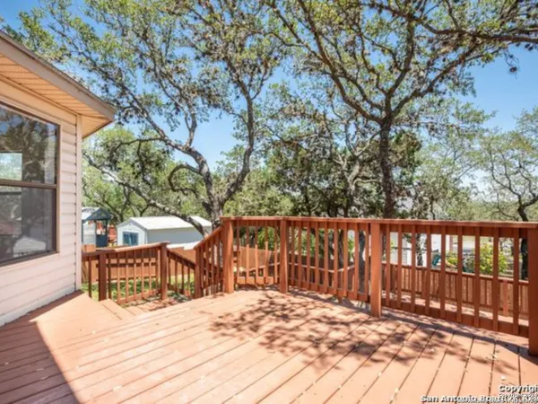 a view of wooden deck and a backyard