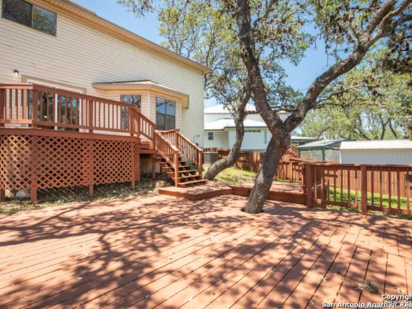 a view of a house with a yard from a tree