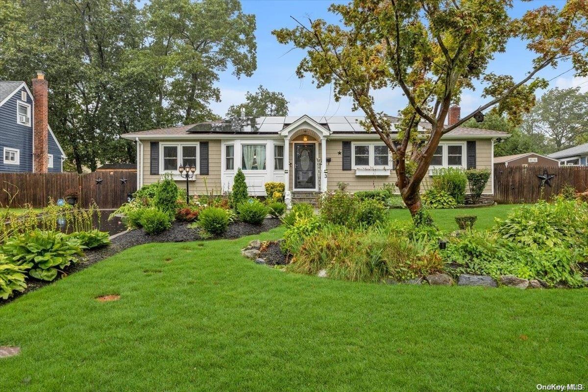 3 Chauser Drive Greenlawn, NY 11740 - Photo 1 of 1 a front view of a house with a garden