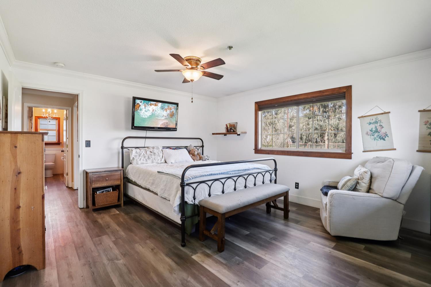 11213 Colony Road Wilton, CA 95693 - Photo 20 of 48 a spacious bedroom with a bed and a couch