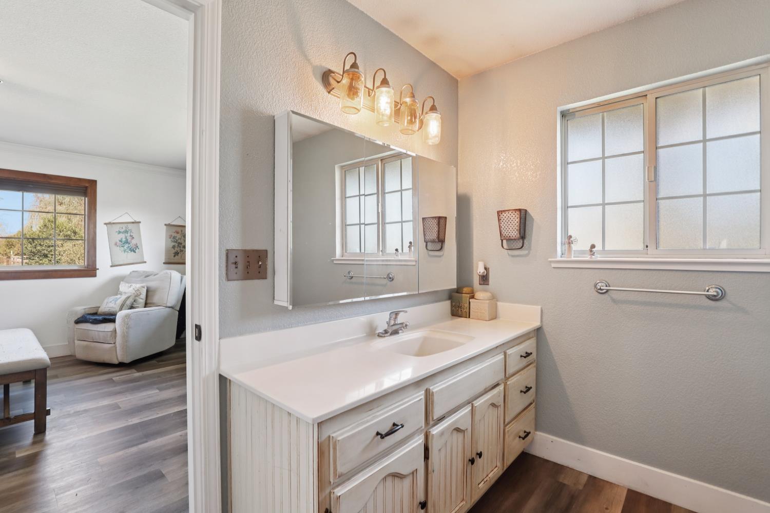 11213 Colony Road Wilton, CA 95693 - Photo 21 of 48 a bathroom with a sink a vanity and a large mirror