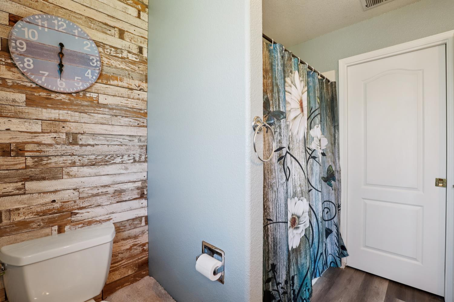 11213 Colony Road Wilton, CA 95693 - Photo 23 of 48 a bathroom with a toilet and a shower curtain