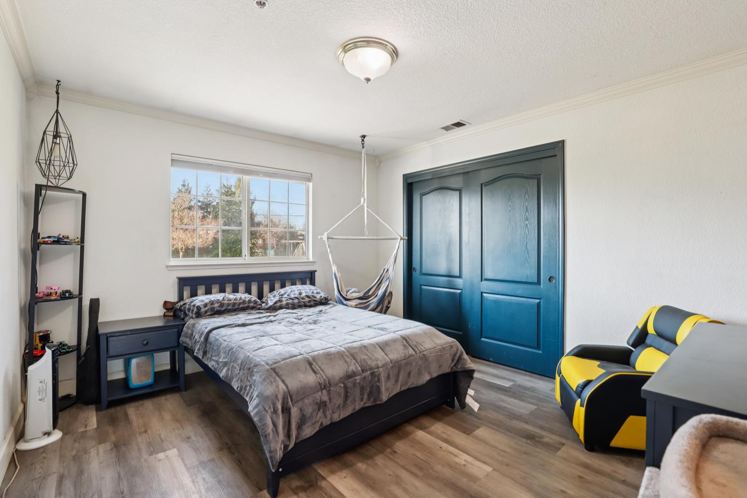 11213 Colony Road Wilton, CA 95693 - Photo 25 of 48 a bedroom with a bed and wooden floor