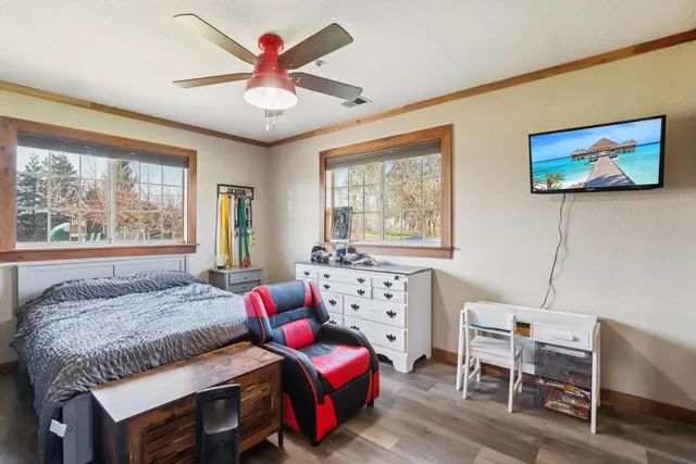 a bedroom with a bed and a chandelier
