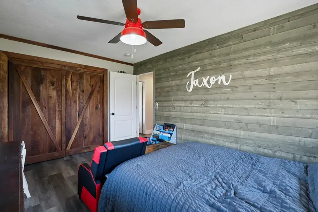 a bedroom with a bed and a chandelier