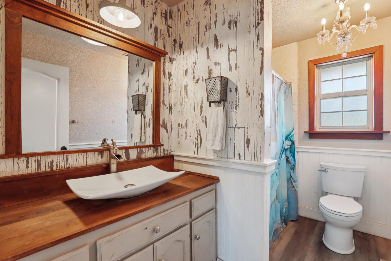 11213 Colony Road Wilton, CA 95693 - Photo 29 of 48 a bathroom with a granite countertop sink toilet and a mirror