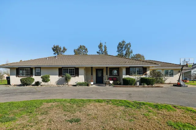 a front view of a house with yard patio and fire pit