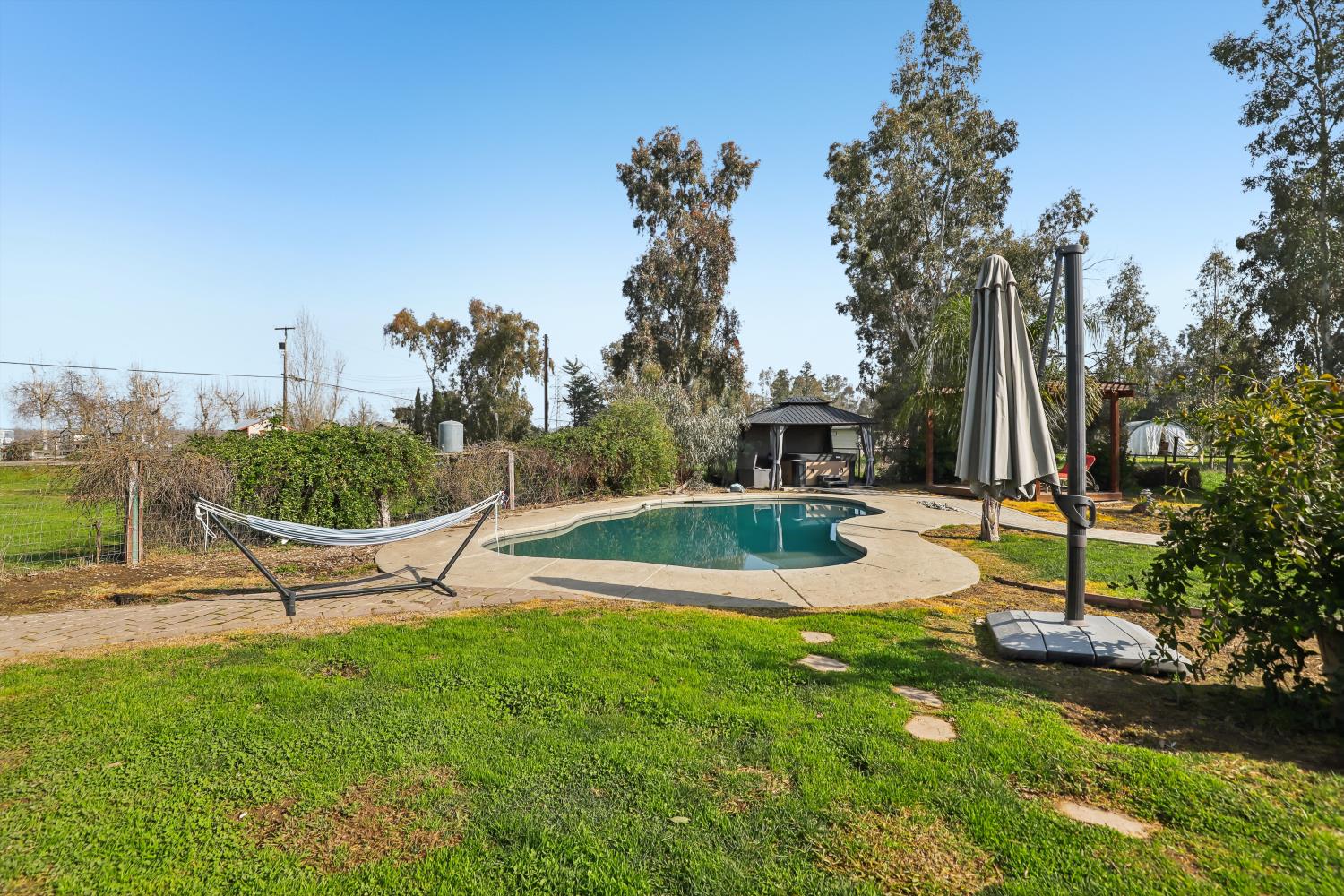 11213 Colony Road Wilton, CA 95693 - Photo 35 of 48 a view of a swimming pool with a garden