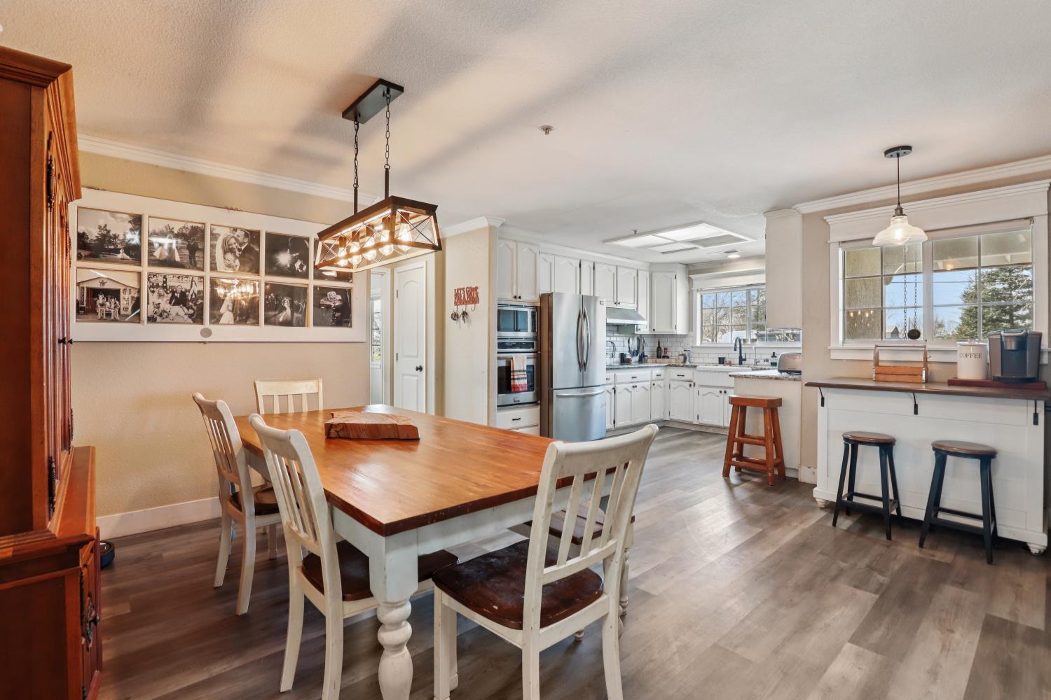 11213 Colony Road Wilton, CA 95693 - Photo 5 of 48 a dining room with furniture a chandelier and wooden floor