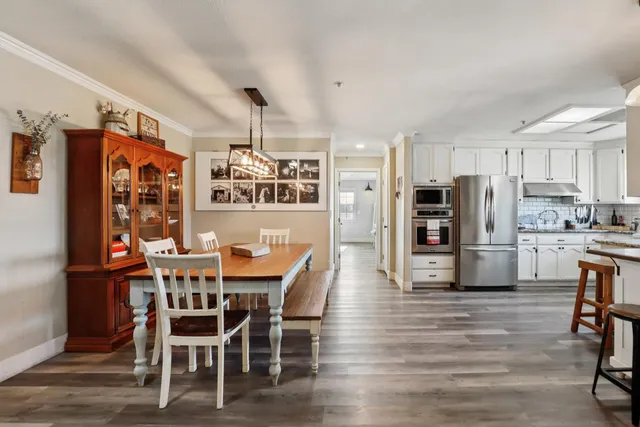 a view of a dining room with furniture and wooden floor