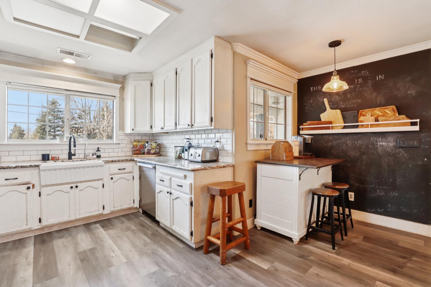 11213 Colony Road Wilton, CA 95693 - Photo 10 of 48 a kitchen with sink cabinets and wooden floor