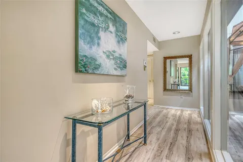 a living room with furniture flat screen tv and couches