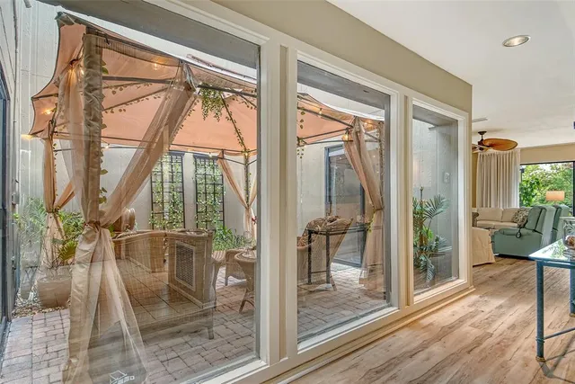 a view of a dining room and livingroom furniture wooden floor a chandelier
