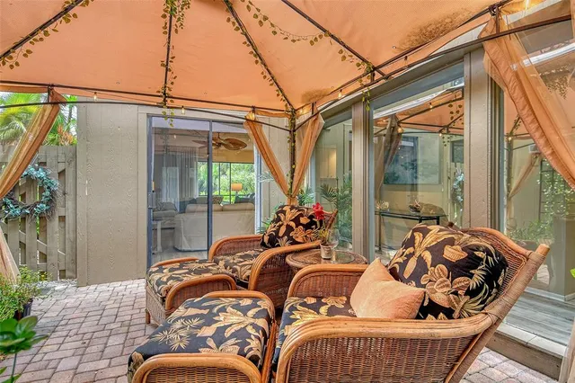 a dining room with furniture a chandelier and wooden floor