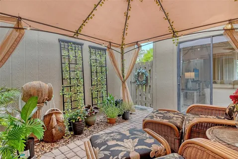 a view of a chairs and table in patio