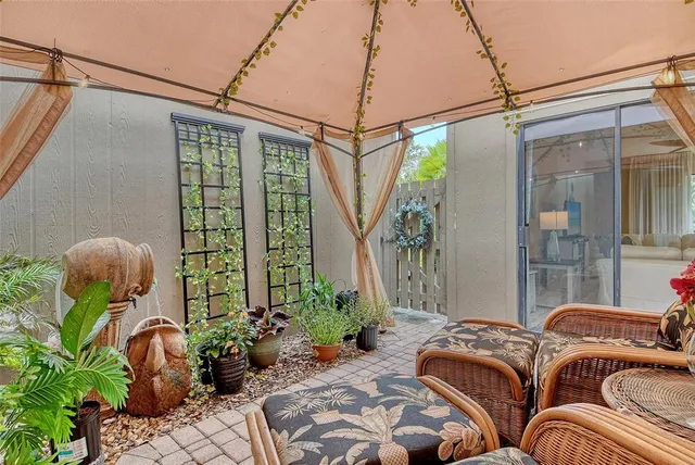 a view of a chairs and table in patio