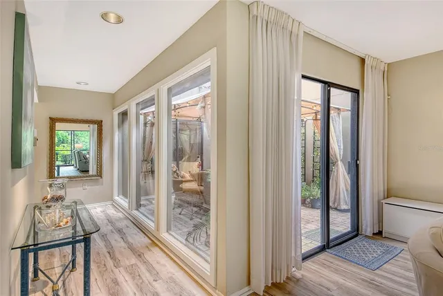 a view of a porch with furniture and garden