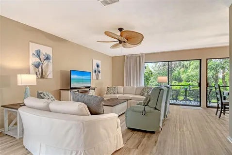 a living room with furniture and a floor to ceiling window