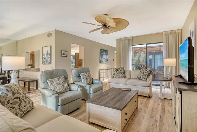 a kitchen with kitchen island granite countertop a stove top oven a sink a counter space and cabinets