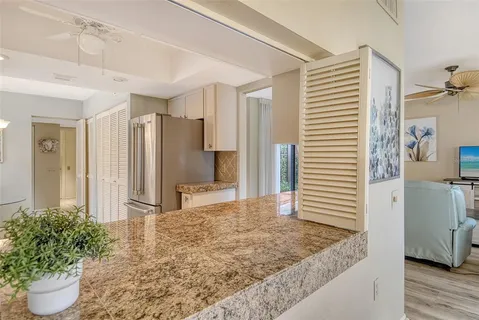 a view of a backyard with table and chairs and a large tree