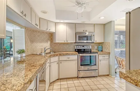 a view of a yard with plants and trees