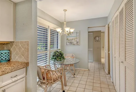 a view of a backyard with plants and lake view