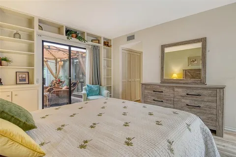a view of a balcony with two chairs and a potted plant