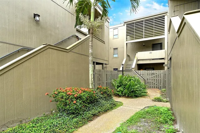 a view of a hallway view with wooden floor and a bathroom