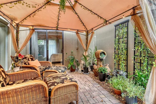 a view of a patio with a table chairs and a fire pit