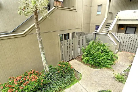 a living room with a floor to ceiling window and wooden floor