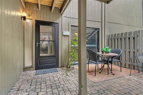 a view of a hallway with wooden floor and dining room view